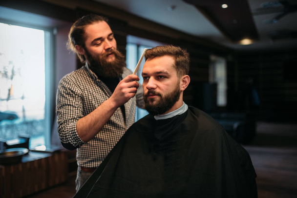barber combing hair of client  - Φωτογραφία, εικόνα