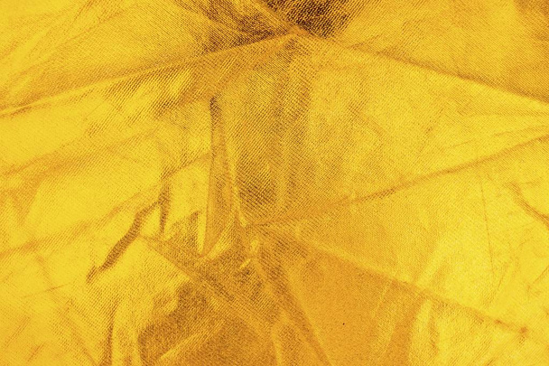 Gold thread on the fabric. Gold texture glitter background. - Valokuva, kuva