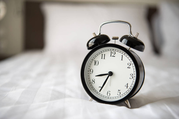alarm clock on bed - Photo, image