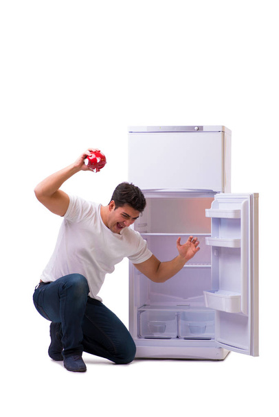 Голодный человек ищет деньги, чтобы заполнить холодильник
 - Фото, изображение
