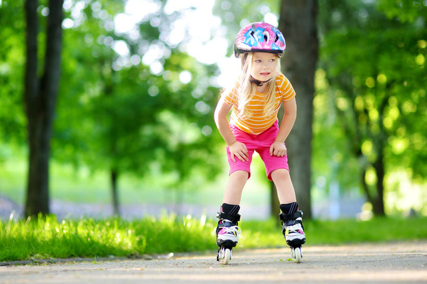 Pretty little girl learning to roller skates - Φωτογραφία, εικόνα