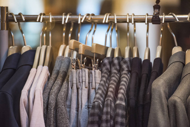 Fashion store - clothing on hangers. - Foto, imagen