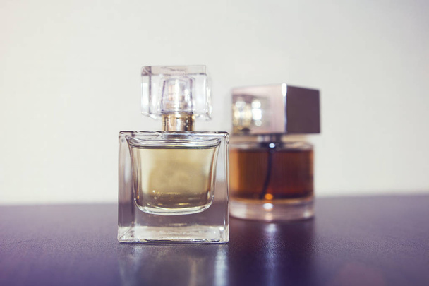 Two bottles of perfume on the table. - Fotoğraf, Görsel