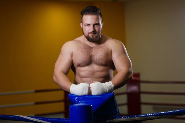 Strong man fighter standing in the boxing ring - Φωτογραφία, εικόνα