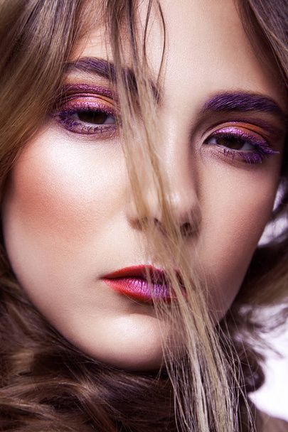 Closeup of beautiful fashion model with makeup and hairstyle on her face. - Foto, Imagem