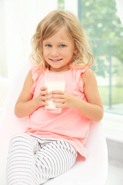 Portrait of little girl with glass of milk - Fotó, kép