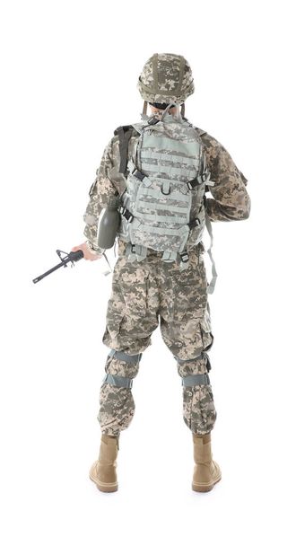 Soldier in camouflage holding rifle, isolated on white - Photo, image