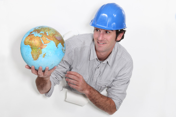 Construction worker holding a globe - Photo, image