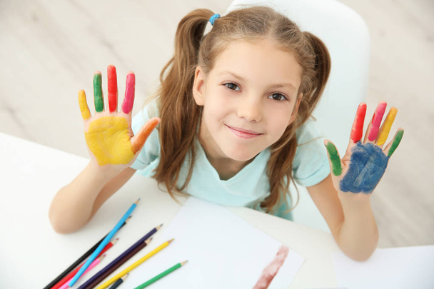 Cute girl with palms in paint at home - Photo, image