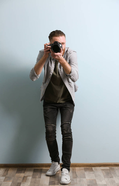 Handsome photographer with camera    - 写真・画像