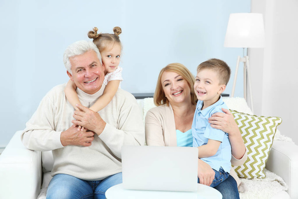 Children and grandparents using laptop at home - Photo, Image