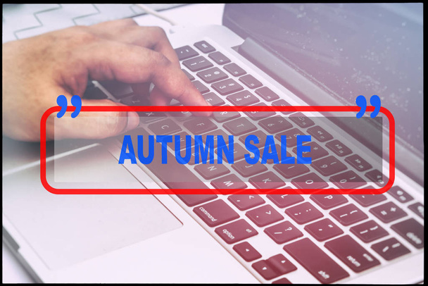 Hand and text  "AUTUMN SALE" with vintage background. Technology concept. - Photo, Image