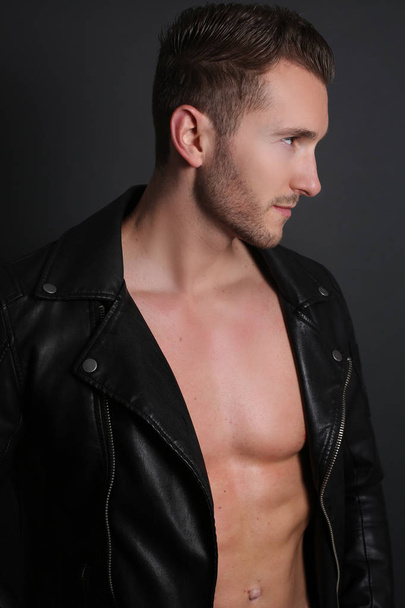 Handsome man shirtless with a black leather jacket  - Foto, immagini