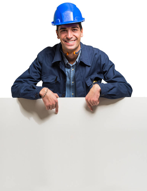Worker showing a white sign - Foto, imagen