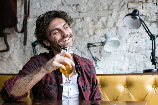 men having beer in a pub - Фото, изображение