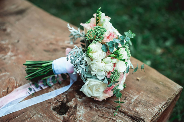 luxury bridal bouquet of white flowers on a wooden board - Фото, изображение
