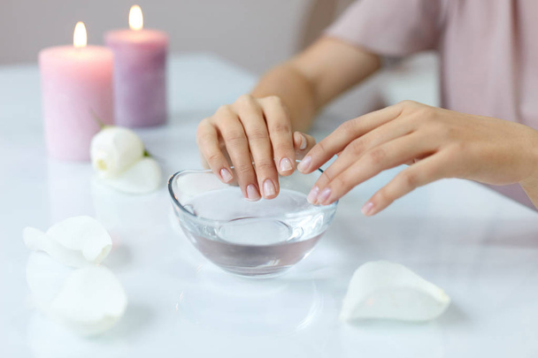 Woman Soaking Natural Nails In Bowl Full Of Water. Nail Care - Fotoğraf, Görsel