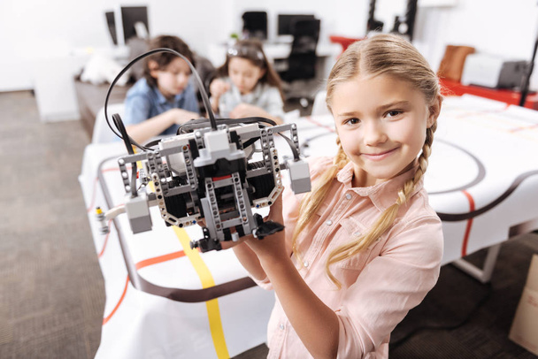 Cute little girl demonstrating robot - Foto, Bild