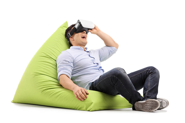 Joyful guy using virtual reality headset  - Foto, afbeelding