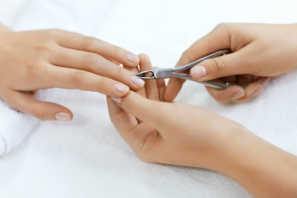 Nails Beauty. Woman Hands Cutting Cuticle With Nail Clippers - Fotó, kép