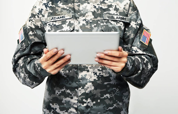 Female soldier with tablet computer  - Фото, изображение