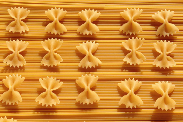 Pasta bows placed on spaghetti. - Photo, image