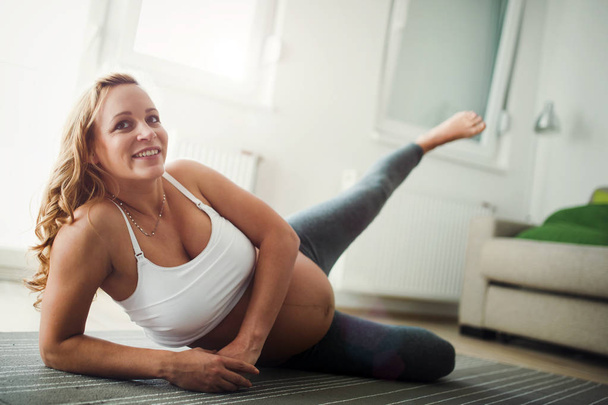 Pregnant woman doing exercises - 写真・画像
