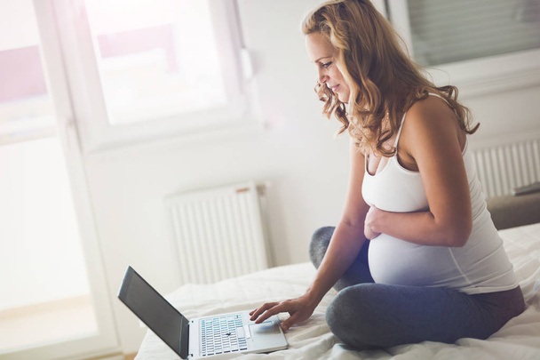 Pregnant woman using leptop - Photo, image