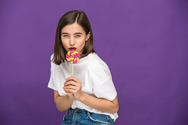 The young woman with colorful lollipop - Фото, зображення
