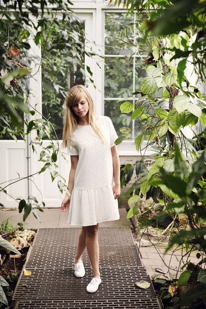 Lady in white dress in garden - 写真・画像