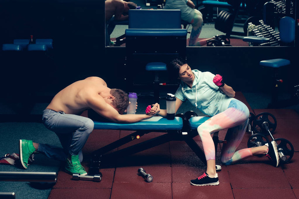 arm wrestling muscular man and girl at gym - 写真・画像
