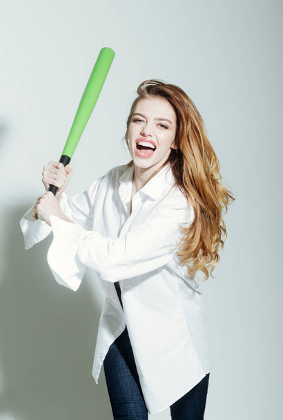 pretty sexy woman with long hair holds green baseball bat - Zdjęcie, obraz