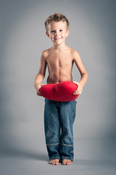 Little boy playing with red heart. Valentines Day concept. - Foto, afbeelding