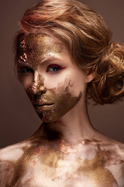 Young girl with creative makeup and textures on her face. Beautiful model with raspberry arrows and golden pigment - Fotó, kép
