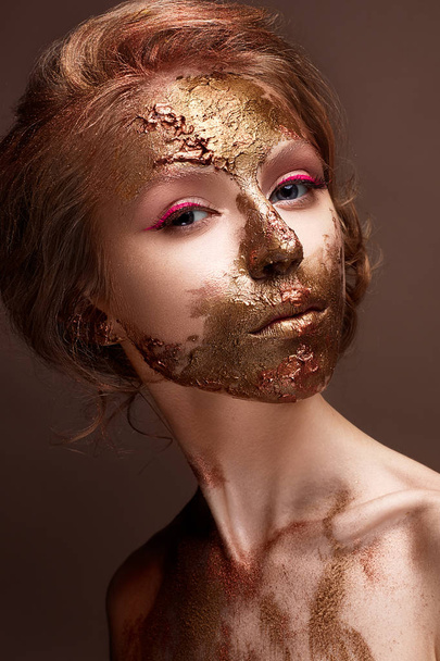 Young girl with creative makeup and textures on her face. Beautiful model with raspberry arrows and golden pigment - Fotó, kép