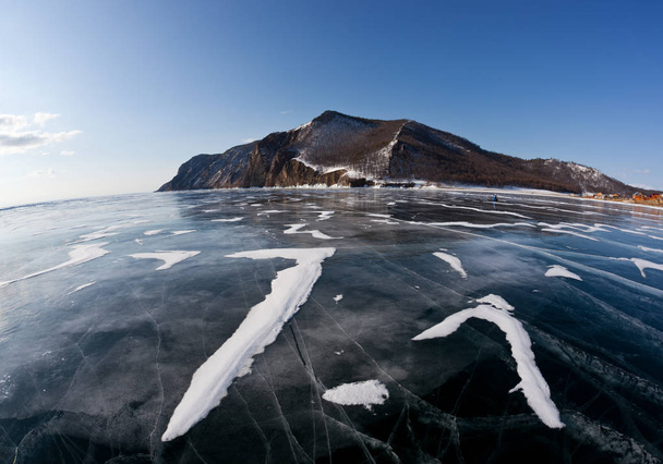 Winter Baikal with clear ice and reflection of rocks - Fotoğraf, Görsel
