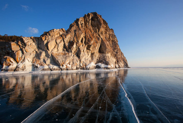Winter Baikal with clear ice and reflection of rocks - 写真・画像