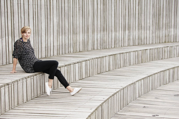 Woman sitting on wooden steps  - Fotografie, Obrázek