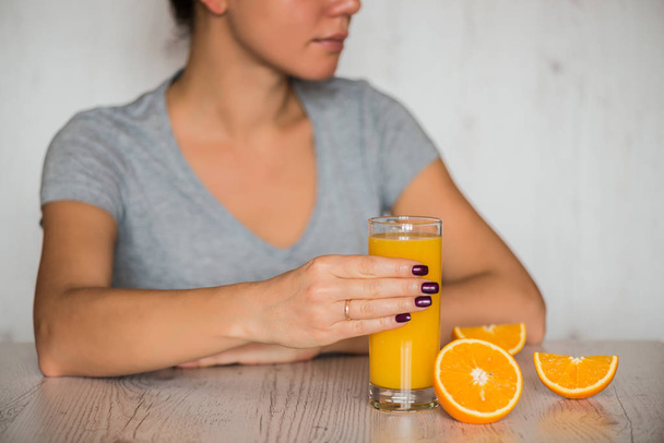 healthy drink, diet, detox and people concept - close up of woman with orange juice in glass - Фото, зображення