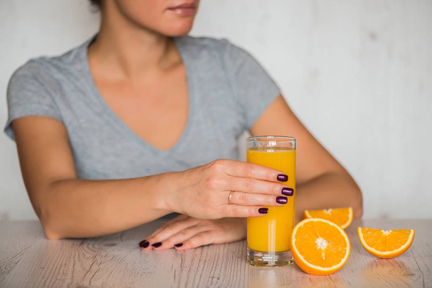 gesundes Getränk, Ernährung, Entgiftung und Menschenkonzept - Nahaufnahme einer Frau mit Orangensaft im Glas - Foto, Bild