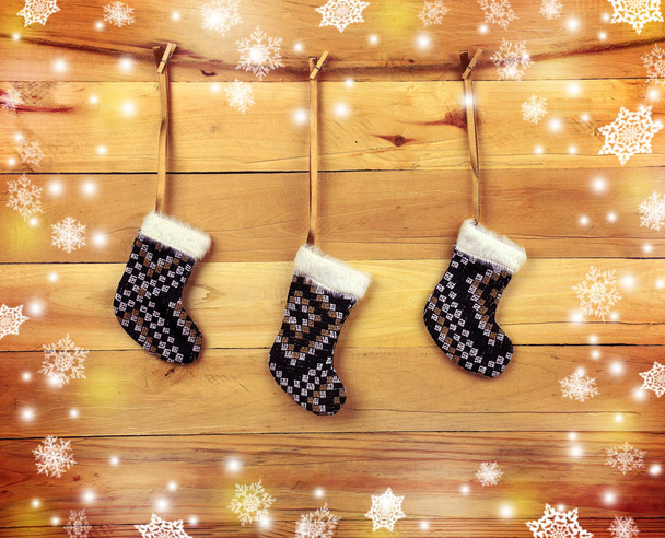 Handmade socks on a wooden background. Christmas atmosphere. - Photo, Image