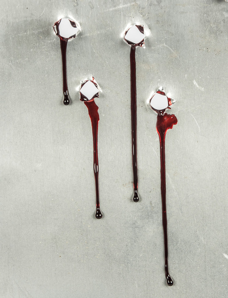 Bloody gunshot holes with blood drips - Photo, Image