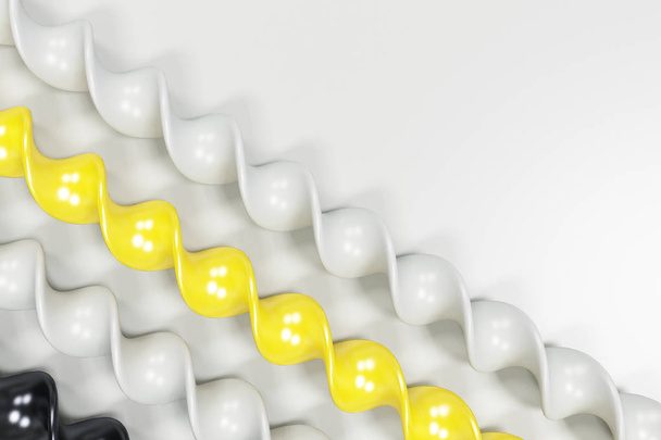 Black, white and yellow plastic spiral sticks on white backgroun - Foto, afbeelding