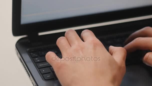 Close up of laptop keyboard. Mans hands typing text - Materiał filmowy, wideo