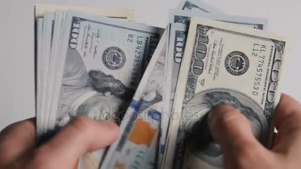 Close-up of a businessmans hands counting hundred dollar bills at a table - Footage, Video
