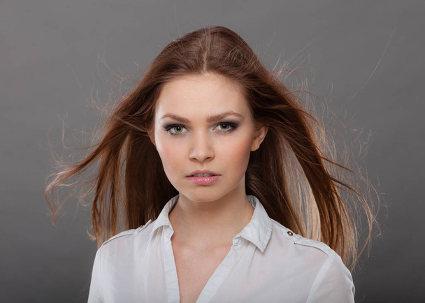 Attractive brunette woman with windblown hair - Foto, imagen