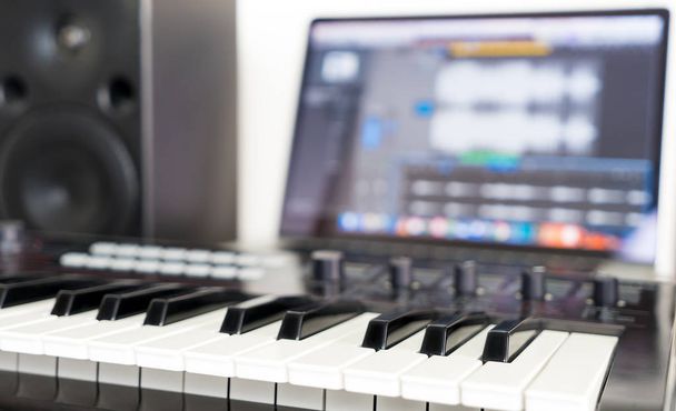 Клавиатура синтезатора лежит на рабочем столе студии Music
 - Фото, изображение