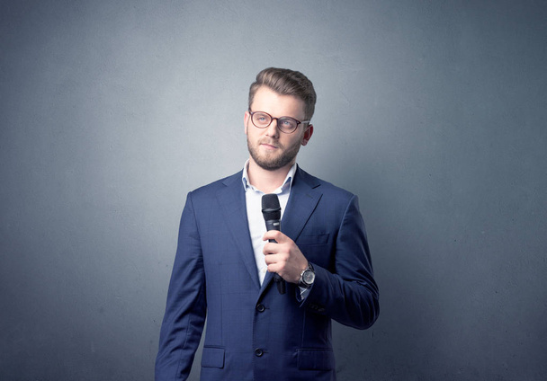 Businessman holding microphone - Zdjęcie, obraz