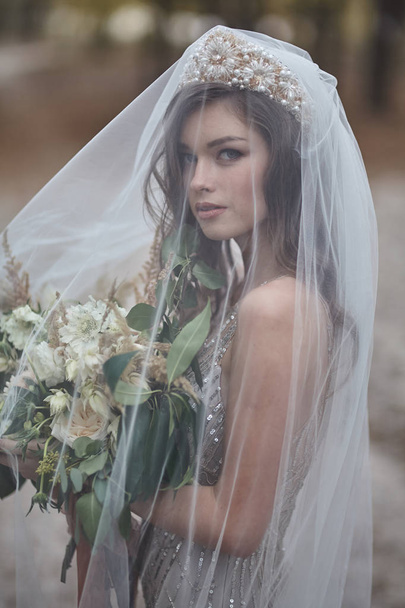 Young bride with flowers - Фото, зображення