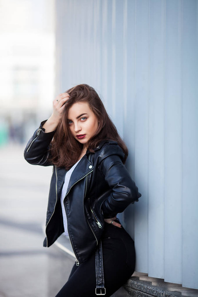 Amazing joyful pretty girl with long brunette hair. posing outdoor. leather jacket,brunette hair, bright red lips - Photo, Image